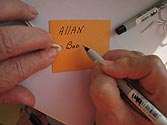 Woman writing son's name on Hope Card