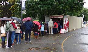 Visitors waiting in the rain to view The Scarlet Cord