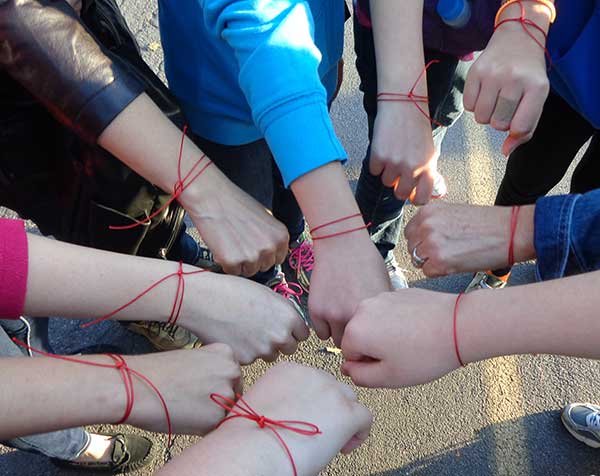 Red string bracelets at The Scarlet Cord