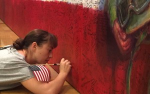 Many ArtPrize visitors, including this young woman, went all the way to the floor to honor their heroes