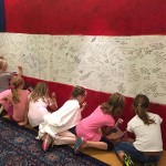 A group of young girls line up to honor heroes