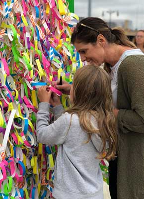 ArtPrize Ten visitors adding kindness promise ribbons to the Broken Wings interactive installation