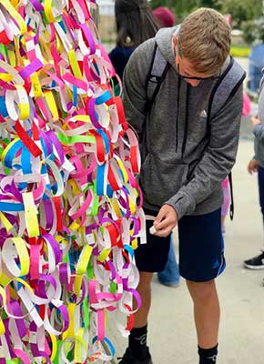 ArtPrize Ten visitors adding kindness promise ribbons to the Broken Wings interactive installation
