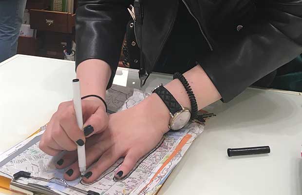 A young woman creating an Open Hands line drawing in NYC
